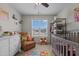 Charming Bedroom with crib, ceiling fan, area rug and an abundance of natural light at 135 Campaign Dr, Mebane, NC 27302