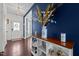 Stylish entryway featuring dark wood floors, navy accent wall, and decorative console table at 135 Campaign Dr, Mebane, NC 27302