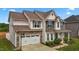 Beautiful two-story home featuring a two-car garage, well-maintained lawn, and covered front porch at 135 Campaign Dr, Mebane, NC 27302