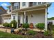 Inviting front porch with wood chairs and lush landscaping, perfect for enjoying outdoor living at 135 Campaign Dr, Mebane, NC 27302