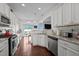 Bright kitchen featuring granite countertops, stainless appliances, and view to back yard at 135 Campaign Dr, Mebane, NC 27302