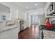 Open kitchen with white cabinets, stainless steel appliances, and granite countertops at 135 Campaign Dr, Mebane, NC 27302