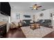 Spacious living room features black leather sofas, a plush shag rug, and a cozy fireplace at 135 Campaign Dr, Mebane, NC 27302
