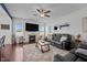 Comfortable living room with a black leather sofas, plush shag rug, and fireplace, great for relaxing at 135 Campaign Dr, Mebane, NC 27302