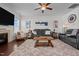 Comfortable living room featuring a fireplace, ceiling fan and plush, neutral colored rug at 135 Campaign Dr, Mebane, NC 27302