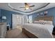 The beautiful main bedroom features an ensuite bathroom and trey ceilings with a ceiling fan at 135 Campaign Dr, Mebane, NC 27302