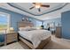 Spacious main bedroom features cool colored walls and modern furnishings with a ceiling fan at 135 Campaign Dr, Mebane, NC 27302