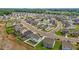An aerial view showcases a well-planned neighborhood with sidewalks and community pool at 135 Campaign Dr, Mebane, NC 27302