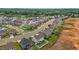 A high angle displays a well-maintained suburban neighborhood with manicured lawns at 135 Campaign Dr, Mebane, NC 27302