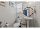 Modern powder room with pedestal sink, round mirror, and stylish décor for guests' convenience at 135 Campaign Dr, Mebane, NC 27302