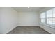 Bright room showcasing gray wood flooring and a window, offering a calming, inviting space at 139 Palm Drive Dr, Sanford, NC 27332