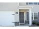 Exterior featuring a gray front door with a brick facade and two-car garage at 139 Palm Drive Dr, Sanford, NC 27332