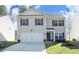 Charming two-story home featuring a two-car garage, classic shutters, and a well-manicured lawn at 139 Palm Drive Dr, Sanford, NC 27332