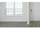 Bright interior view with wood floors, a large window, and a white front door at 139 Palm Drive Dr, Sanford, NC 27332