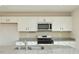 Kitchen featuring white cabinetry, granite countertops, and stainless steel microwave at 139 Palm Drive Dr, Sanford, NC 27332