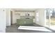 Modern kitchen featuring a green island, stainless steel appliances, and sliding glass doors at 139 Palm Drive Dr, Sanford, NC 27332