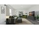 Stylish living room with gray sofa, green accents, modern furniture, and ample natural light at 139 Palm Drive Dr, Sanford, NC 27332