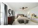 Cozy bedroom with elegant decor, a ceiling fan, dresser, and natural light for relaxation at 139 Palm Drive Dr, Sanford, NC 27332