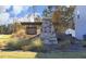 Community sign for Laurel Oaks, featuring stone pillar and professionally landscaped entrance at 139 Palm Drive Dr, Sanford, NC 27332