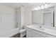 A bright, clean bathroom is showcased with a tub and shower combination, vanity, and large mirror at 141 Gladstone Loop, Clayton, NC 27520