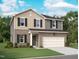 Two-story home features a brick and siding exterior, attached two-car garage, and professionally landscaped front yard at 141 Gladstone Loop, Clayton, NC 27520