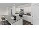 Modern kitchen features granite countertops, an island with breakfast bar, and white cabinets at 141 Gladstone Loop, Clayton, NC 27520