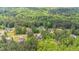 Overhead view of a wooded neighborhood with houses and green space at 175 Grist Mill Dr, Franklinton, NC 27525