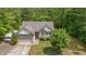 A lush green yard surrounds this one-story home with an attached garage and large driveway at 175 Grist Mill Dr, Franklinton, NC 27525