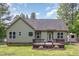 Back of house featuring a wooden deck and fenced in backyard surrounded by trees at 175 Grist Mill Dr, Franklinton, NC 27525