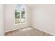 This bedroom boasts natural light from an arched window and plush carpeting at 175 Grist Mill Dr, Franklinton, NC 27525