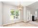 Adjacent dining area features modern light fixture, windows to the back yard, and open layout at 175 Grist Mill Dr, Franklinton, NC 27525