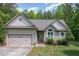Lovely one-story home with green siding, attached garage, and beautiful landscaping at 175 Grist Mill Dr, Franklinton, NC 27525