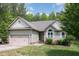 Charming one-story home with a well-manicured lawn, attached garage, and lovely landscaping at 175 Grist Mill Dr, Franklinton, NC 27525