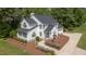 Aerial view of the home featuring a well-maintained lawn, charming walkway, and inviting entrance at 1925 W Lake Dr, Burlington, NC 27215