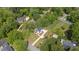 Aerial view of property highlighting its manicured lawn, mature trees, and circular driveway at 1925 W Lake Dr, Burlington, NC 27215