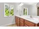 Bathroom featuring a double sink vanity, and natural light from two windows at 1925 W Lake Dr, Burlington, NC 27215