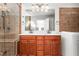 Bathroom with double sink vanity, with tile walls, glass shower, and a large mirror at 1925 W Lake Dr, Burlington, NC 27215