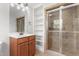 Bathroom featuring a shower, vanity with storage, tiled walls, and carpet at 1925 W Lake Dr, Burlington, NC 27215