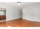 Neutral bedroom with hardwood floors leading to a bathroom, with white crown molding, and baseboards at 1925 W Lake Dr, Burlington, NC 27215