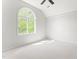 Bright bedroom with vaulted ceiling and an arched window overlooking greenery at 1925 W Lake Dr, Burlington, NC 27215