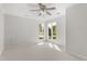 Bright bedroom with neutral carpet and windows overlooking landscaped greenery at 1925 W Lake Dr, Burlington, NC 27215
