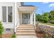 Close-up of a home's front entrance with a light blue door and brick steps at 1925 W Lake Dr, Burlington, NC 27215