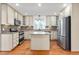 Spacious kitchen featuring a center island, stainless steel appliances, and ample cabinetry at 1925 W Lake Dr, Burlington, NC 27215