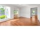 Bright living room with hardwood floors, white trim and large windows overlooking the front yard at 1925 W Lake Dr, Burlington, NC 27215
