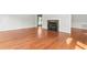 Bright living room featuring hardwood floors, fireplace, and view to porch or deck at 1925 W Lake Dr, Burlington, NC 27215