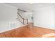 Bright living room with hardwood floors, white trim, staircase and an arch-shaped window at 1925 W Lake Dr, Burlington, NC 27215