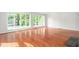 Bright, open living room featuring wood floors and large windows at 1925 W Lake Dr, Burlington, NC 27215