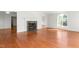 Bright living room featuring hardwood floors, fireplace, and large window at 1925 W Lake Dr, Burlington, NC 27215