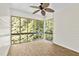 Bright sunroom with large windows offering views of lush greenery and light wood-look floors at 1925 W Lake Dr, Burlington, NC 27215