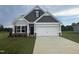 Charming two-story home with a manicured lawn and a two car garage at 202 E Victory View Ter, Smithfield, NC 27577